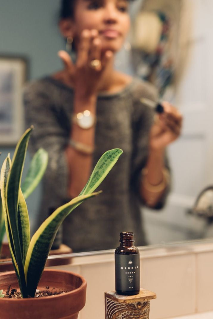 girl using facial cbd serum on neck