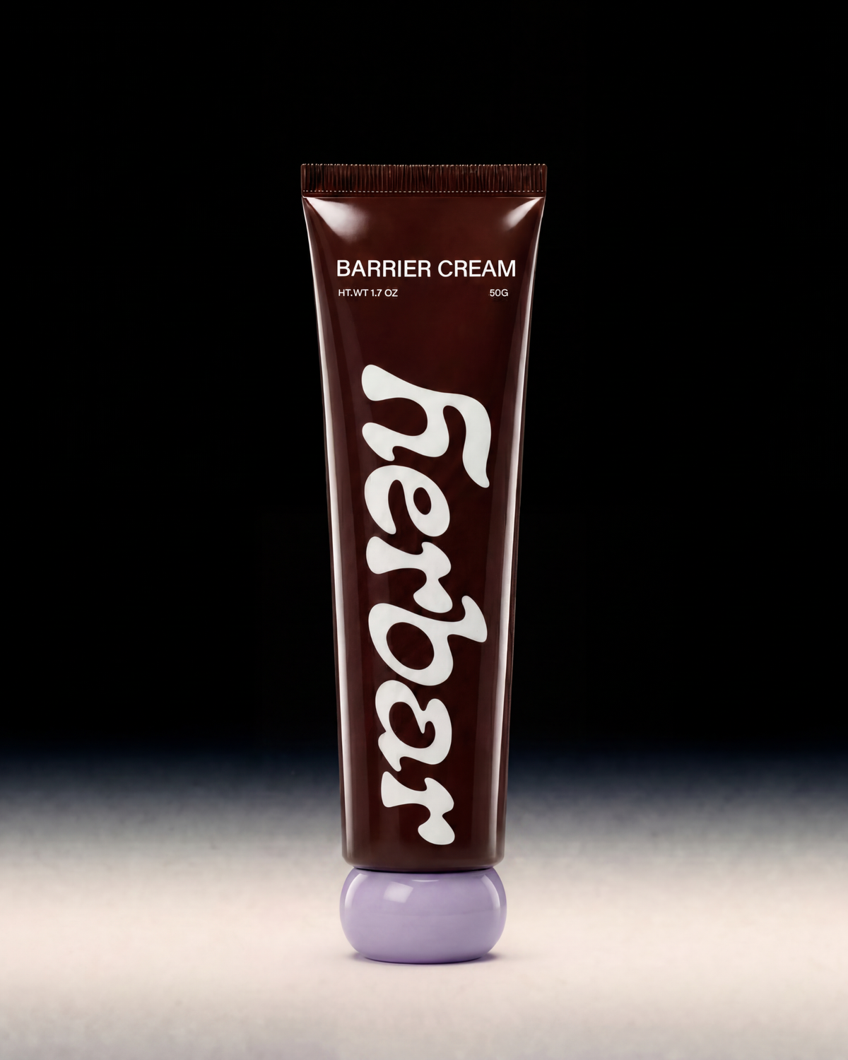 A squeeze tube of Herbar Barrier Cream with a dark brown body, white text, and a light purple cap, set against a black background with a gray surface below.